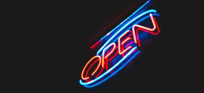 open neon sign against night sky